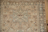 Distressed Karaja runner section with geometric motifs, featuring beige, slate blue, and brown colors.
