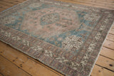 Distressed vintage Persian Abadeh rug with dusty mauve and sky blue quatrefoil design.