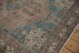 Distressed Abadeh rug detail showing dusty mauve, sky blue geometric blossoms, and worn texture.