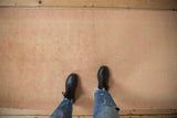 Soft hand-knotted pile of a vintage distressed Oushak runner in dusty pink and sand colors.