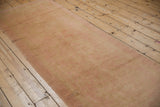 The soft, low pile texture and restored side cord of a distressed vintage Oushak runner.