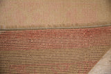 A view of the hand-knotted foundation and soft, distressed pile of a Turkish Oushak rug.