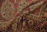 Distressed texture and folded motifs of a vintage Turkish Oushak rug in rose and gold tones.
