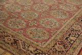 Oushak rug main border displays meandering hook and latch vine in dark brown, gold, and rose.