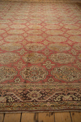 Distressed Oushak rug border, meandering vine and hook patterns in chocolate and gold.