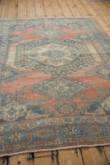 Distressed Veece rug texture, revealing a heavily abrashed blush and sky blue geometric pattern.