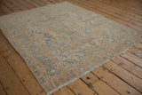 Distressed vintage Persian Ahar rug texture, faded dusty blue patterns on a beige field with wear.