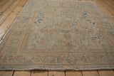 Distressed vintage Persian Ahar rug border, blue samovar motif, visible fringe, and worn pile.