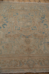 Distressed Ahar rug close-up showing worn beige and dusty blue Samovar border.