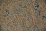 Textured pile of the distressed Ahar rug, highlighting worn blue motifs on beige.