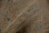 Distressed vintage Persian Ahar rug close-up showing worn beige pile and faded dusty blue patterns.