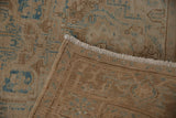Vintage distressed Ahar rug showing its woven foundation, original fringe, and faded blue motifs.