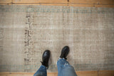 Overhead view of a vintage Hamadan runner showing its distressed texture and worn pattern.