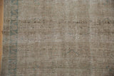 Ribbed texture and worn knot heads on the vintage Persian rug in silver and pale blue.