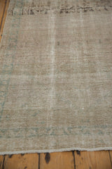 Textural detail of a distressed Persian Hamadan runner showing visible knot heads and low, even pile.