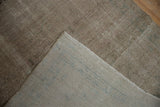 Close-up of a vintage Hamadan runner's hand-knotted foundation and distressed, textured pile.