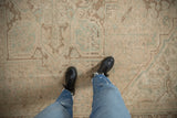 Distressed vintage Heriz carpet with visible even wear and geometric patterns.