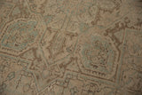 Faint foundation showing through distressed beige, brown, and seafoam green geometric motifs.