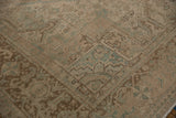 Distressed Heriz carpet corner with geometric vinery, turtle border, and time-softened pile.