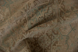 Distressed Heriz rug pile, revealing even wear, beige, and seafoam green geometric vinery.