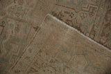 Distressed vintage Heriz carpet, close-up of worn pile, faint foundation, intact selvage.