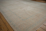 Distressed vintage Birjand carpet texture, revealing faded sand, beige, and powder blue Herati motifs.