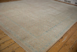 Distressed Birjand rug, faded sand and powder blue Herati pattern with soft worn texture.