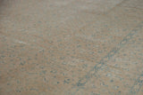 Soft distressed wool pile in sand with faded dusty blue Herati pattern.