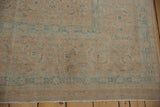 Distressed vintage Birjand carpet with soft, worn sandy beige field and powder blue Herati motifs.