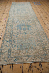 Distressed geometric powder blue and ivory pattern with serrated leaf border.