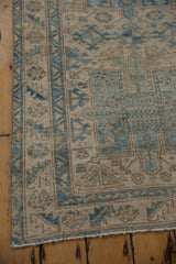 Distressed Karaja rug corner, with visible wear, beige ground, and powder blue geometric patterns.