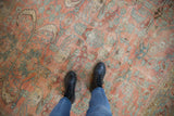 Vintage Lilihan carpet with faded floral arabesques and distressed texture in blush, blue, gold.