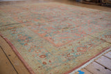 Distressed vintage Lilihan carpet with faded blush, ocean blue, and gold floral vines.