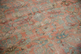 Distressed texture, faded raspberry red and dusty blue floral on vintage Lilihan carpet.