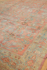 Textural detail of vintage distressed Lilihan carpet, faded floral motifs in blush, gold, and ocean blue.