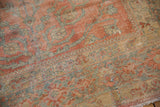 Faded blush, gold, and ocean blue floral arabesques on vintage distressed Lilihan carpet.