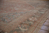 Distressed Mahal carpet border with palmette vine, pawn motifs, faded red, slate blue hues.