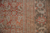 Distressed Mahal rug with dusty red mahi-mahi Herati, pawn motif, and palmette border.