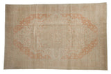 Vintage distressed Kayseri carpet with a terracotta starburst medallion on a dusty beige field.