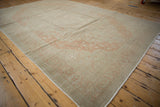 Angled view of a vintage Kayseri carpet highlighting its terracotta pattern and time-softened low pile.