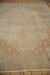 Angled view across the vintage Kayseri carpet, highlighting the faded terracotta pattern and low, worn pile.