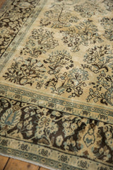 Detailed view of the low pile and knot heads on a distressed Arak floral carpet.