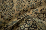 Textured pile and floral sprays of a distressed vintage Arak carpet shown in soft folds.