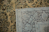 Hand-knotted weave and foundation visible on the back of a vintage distressed Arak rug.