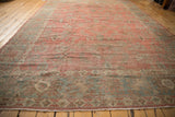 Distressed vintage Mahal carpet detail: worn pile, dusty raspberry field, and faded powder blue border.