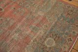 Textured pile of distressed vintage Mahal carpet, with faded dusty raspberry and powder blue floral motifs.