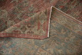 Distressed Mahal rug corner: worn dusty raspberry pile, intact selvage, and tightly woven foundation.