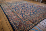 Vintage Mahal rug corner displays hand-knotted texture, terracotta borders, and blue mahi-mahi Herati motifs.