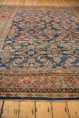 Vintage Mahal carpet border displaying terracotta, dark denim blue, and ivory traditional motifs.