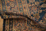 Traditional Persian Mahal carpet's secured dark selvage and border details.